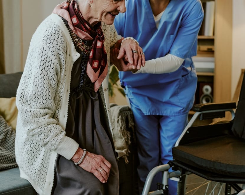 Senior woman receiving assistance from nurse